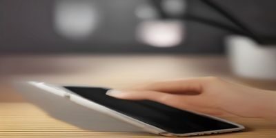 用户在咖啡馆用iPad连接WiFi使用草莓视频ios，桌面有咖啡杯，光线明亮温馨